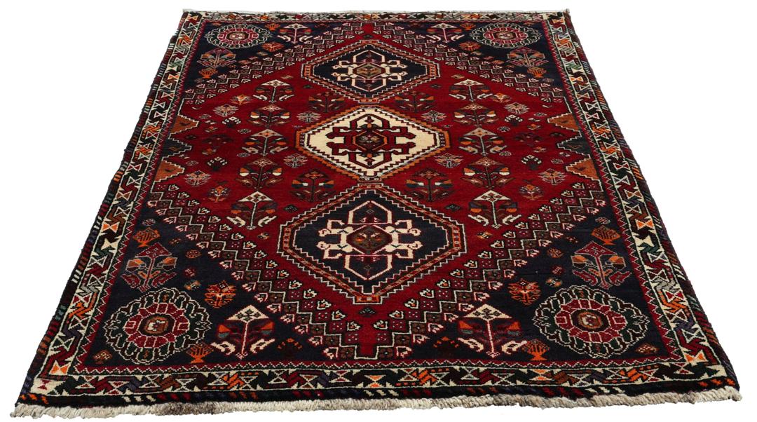 Handmade Shiraz rug from the Middle East featuring a vibrant dark-red and blue geometric design.