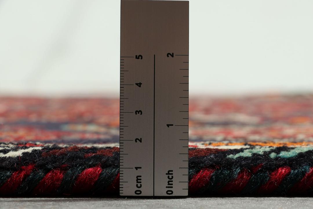 Handmade Shiraz rug from the Middle East featuring a vibrant dark-red and blue geometric design.