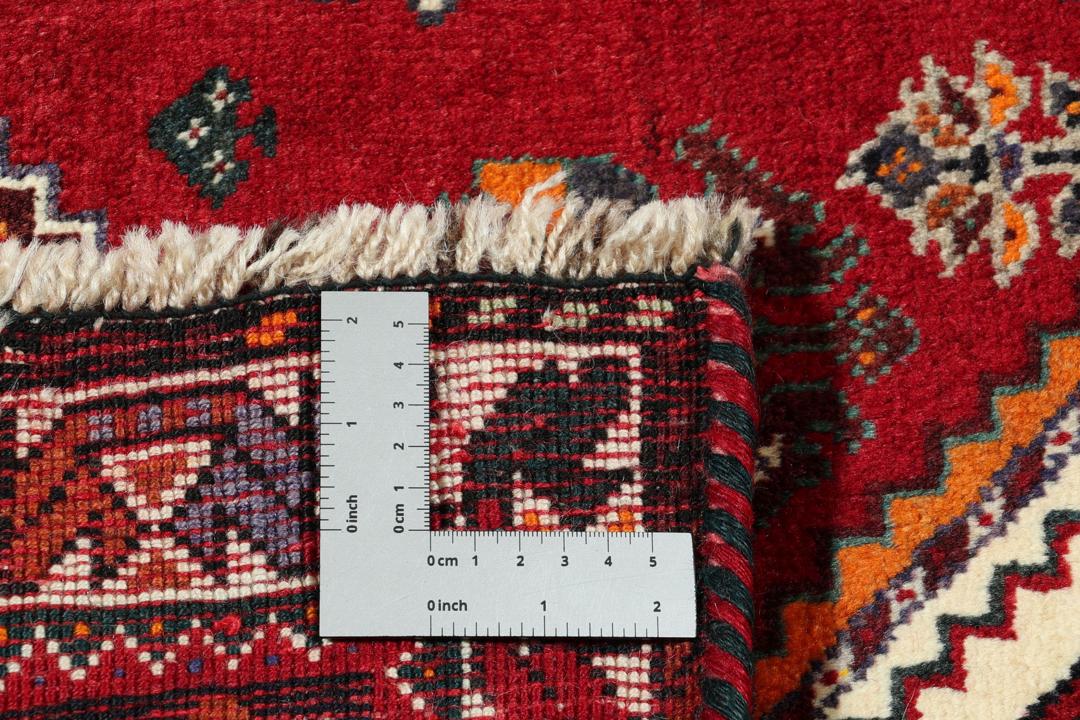 Handmade Shiraz rug from the Middle East featuring a vibrant dark-red and blue geometric design.