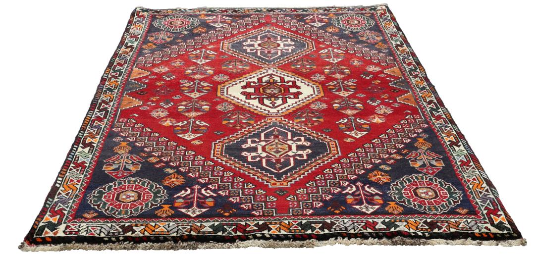 Handmade Shiraz rug from the Middle East featuring a vibrant dark-red and blue geometric design.