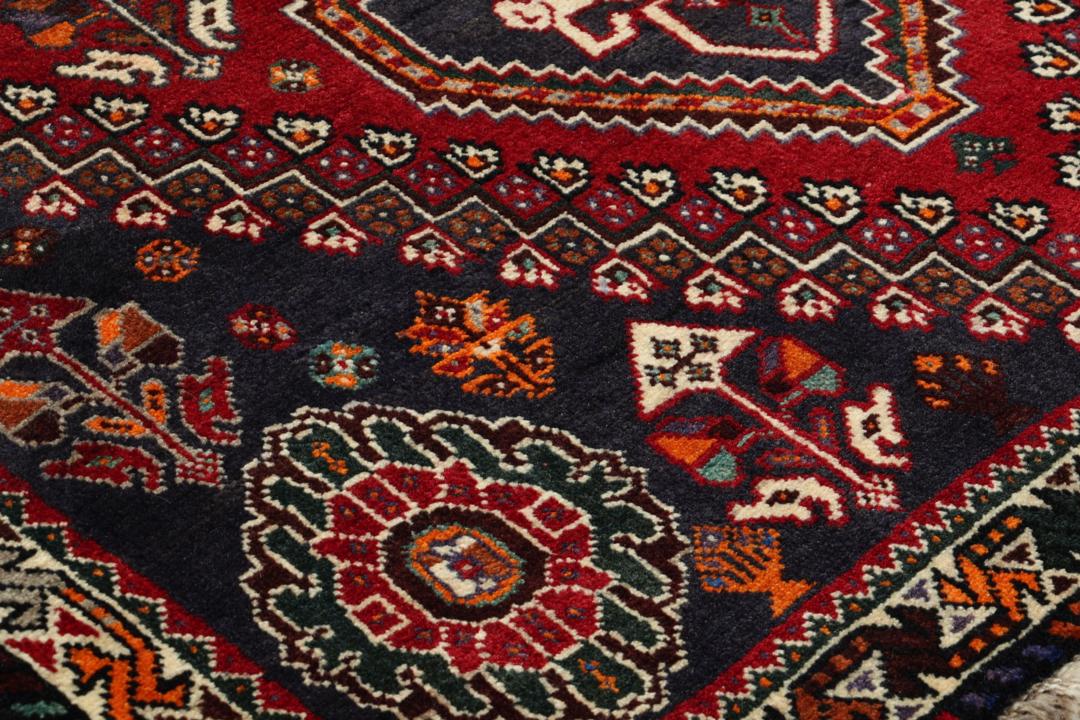 Handmade Shiraz rug from the Middle East featuring a vibrant dark-red and blue geometric design.