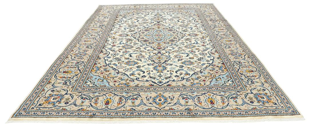 A hand-knotted Keshan rug from the Middle East featuring a blue and beige floral medallion pattern.