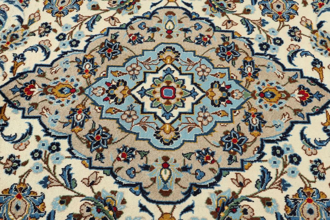 A hand-knotted Keshan rug from the Middle East featuring a blue and beige floral medallion pattern.