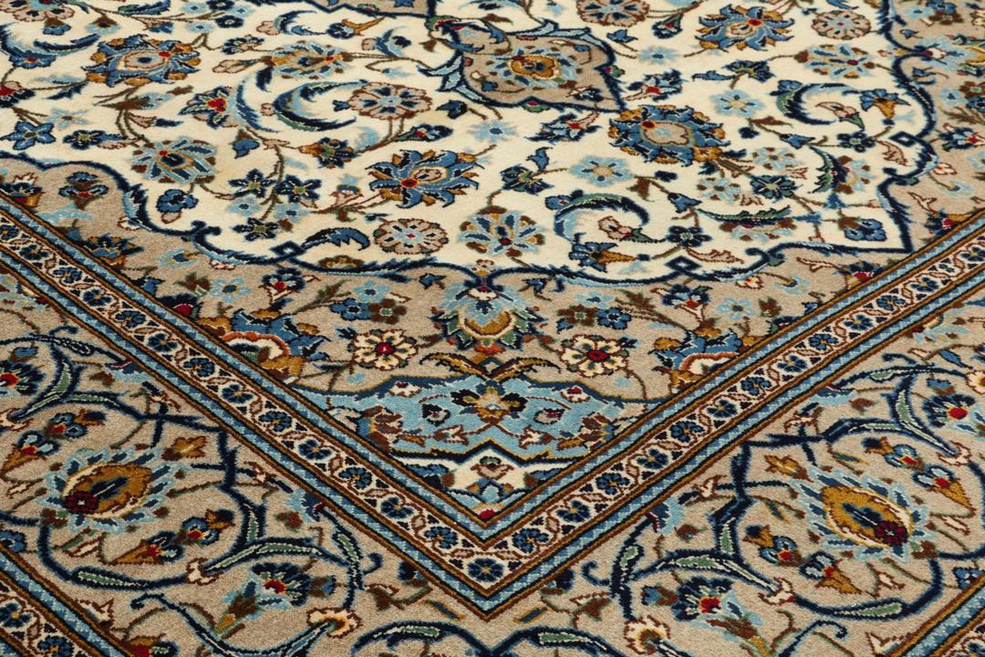 A hand-knotted Keshan rug from the Middle East featuring a blue and beige floral medallion pattern.