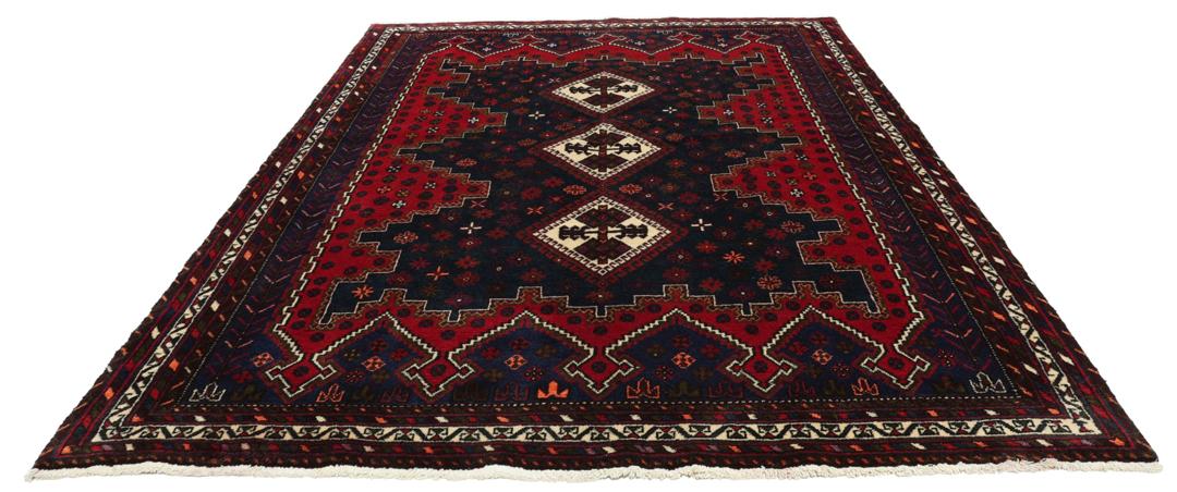 A hand-knotted Afshar rug from the Middle East featuring a vibrant red and blue geometric pattern.