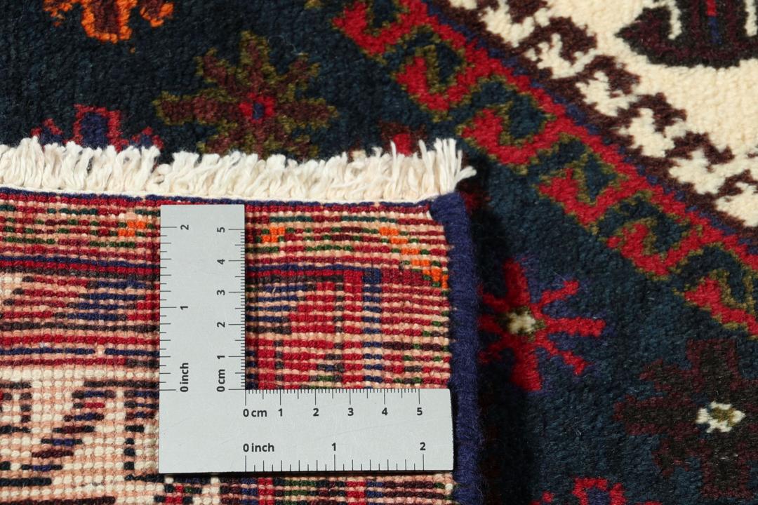 A hand-knotted Afshar rug from the Middle East featuring a vibrant red and blue geometric pattern.