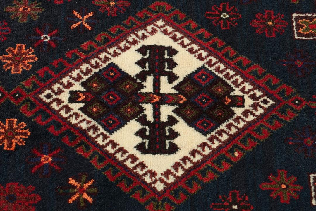 A hand-knotted Afshar rug from the Middle East featuring a vibrant red and blue geometric pattern.