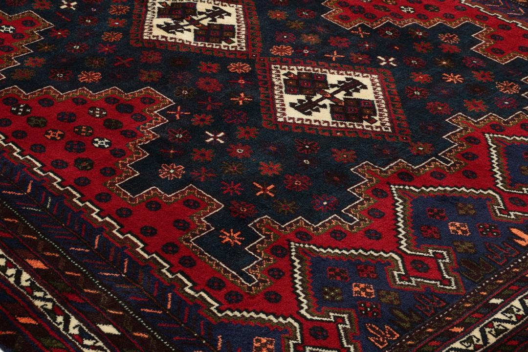 A hand-knotted Afshar rug from the Middle East featuring a vibrant red and blue geometric pattern.