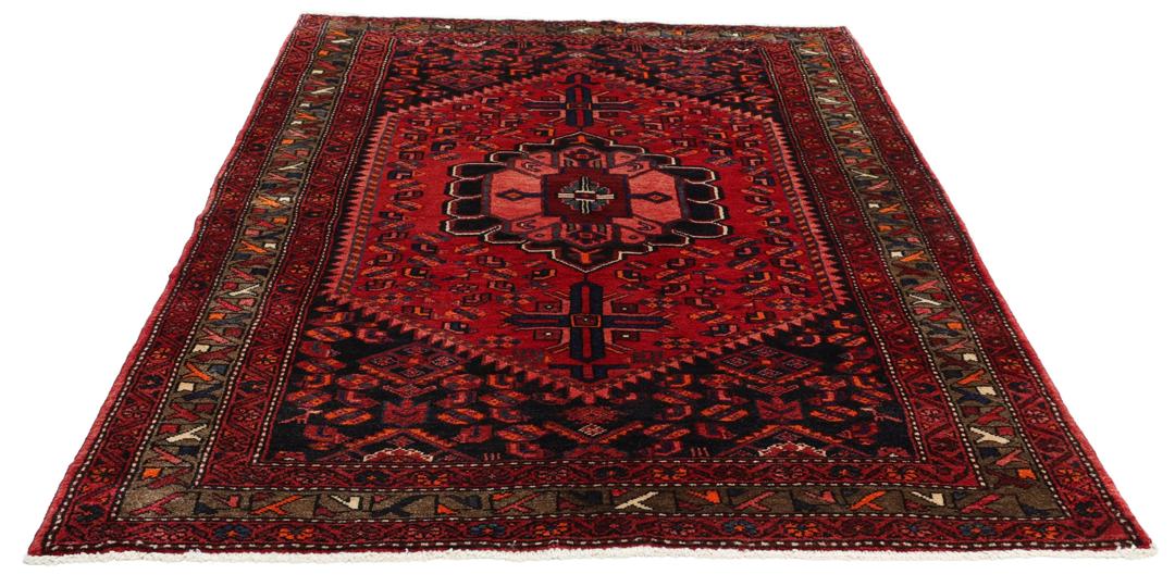 A hand-knotted Hamadan rug from the Middle East in deep red and blue tones.