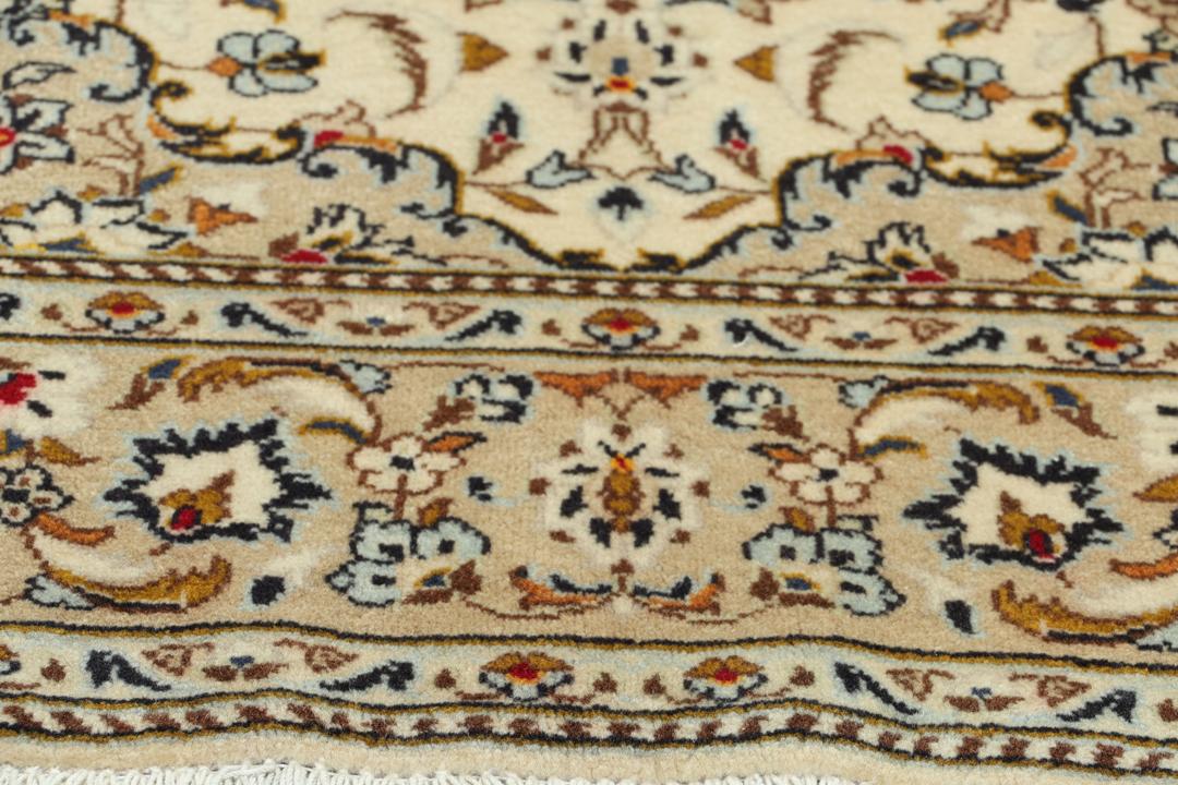 Hand-knotted Keshan rug from the Middle East with a beige base and floral patterns.