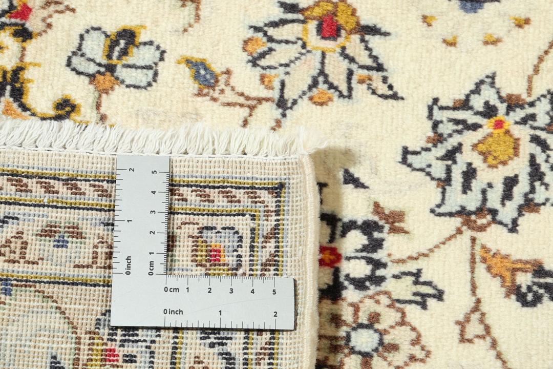 Hand-knotted Keshan rug from the Middle East with a beige base and floral patterns.