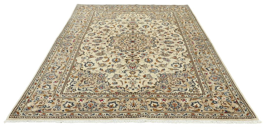 Hand-knotted Keshan rug from the Middle East with a beige base and floral patterns.