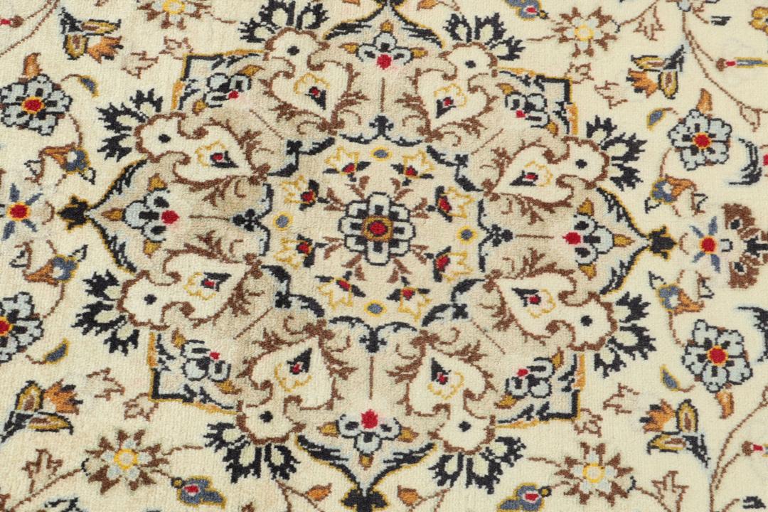 Hand-knotted Keshan rug from the Middle East with a beige base and floral patterns.
