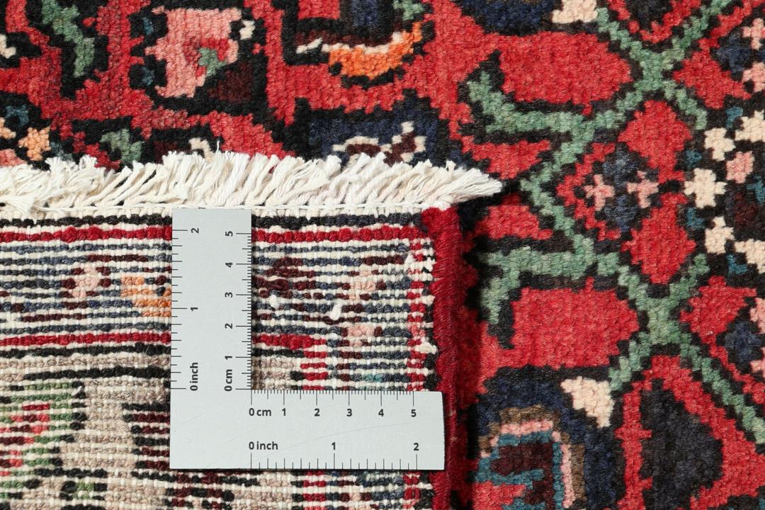 Hand-knotted Hosseinabad runner in red from the Middle East