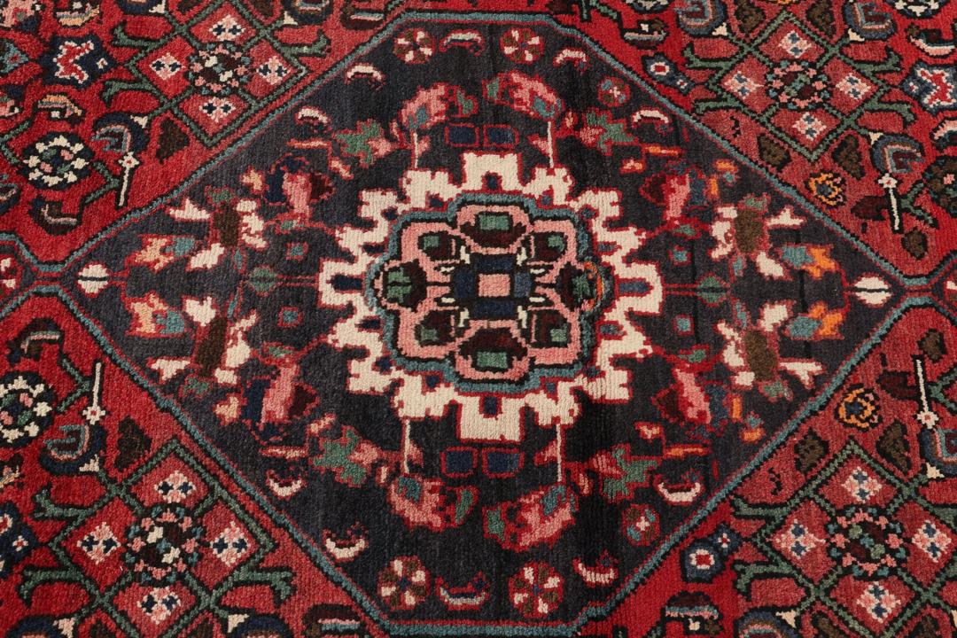 Hand-knotted Hosseinabad runner in red from the Middle East