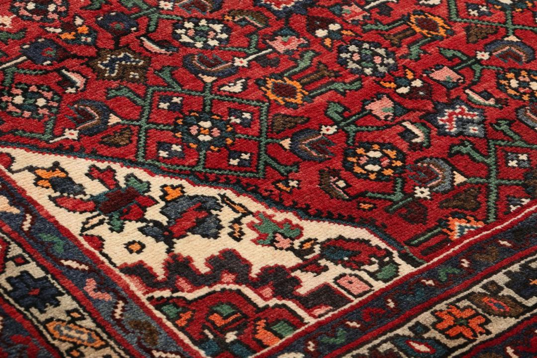 Hand-knotted Hosseinabad runner in red from the Middle East