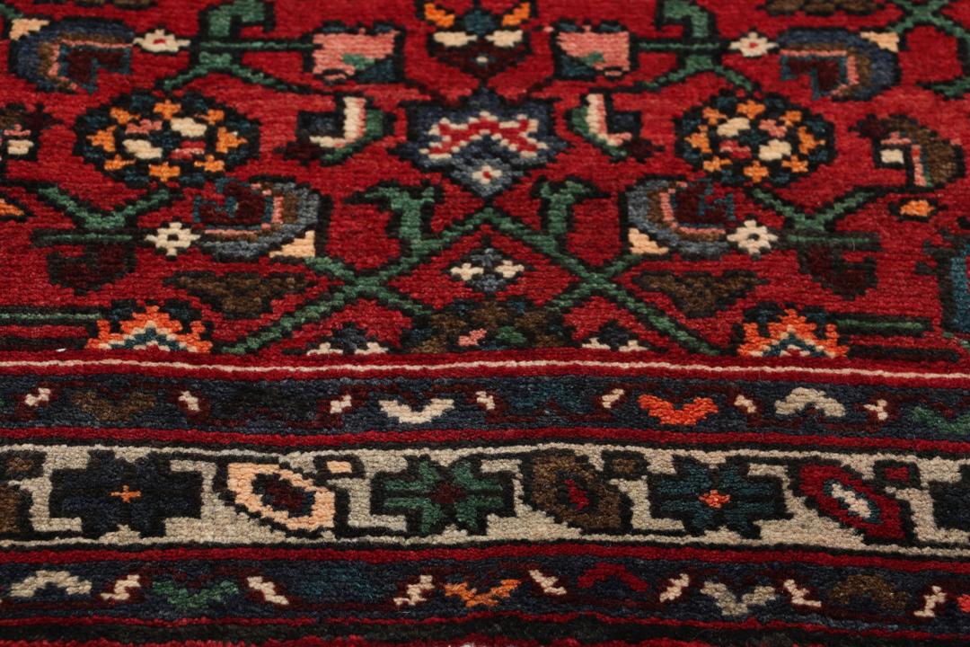 Hand-knotted Hosseinabad runner in red from the Middle East
