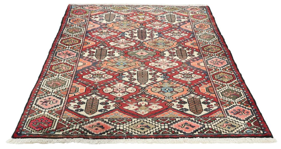 Handgeknoopt tapijt uit het Midden-Oosten in rood met geometrische patronen