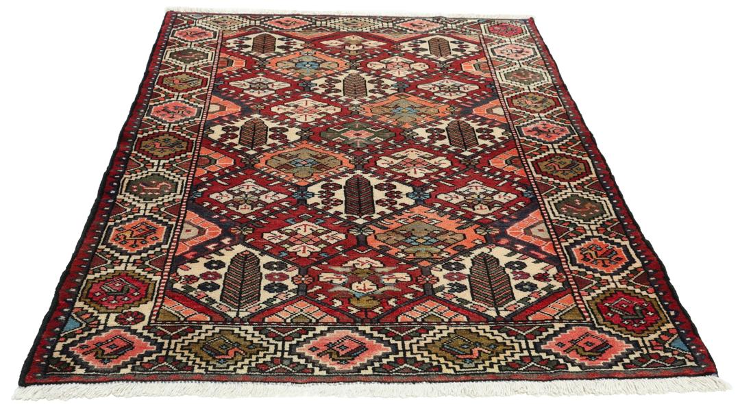 Handgeknoopt tapijt uit het Midden-Oosten in rood met geometrische patronen