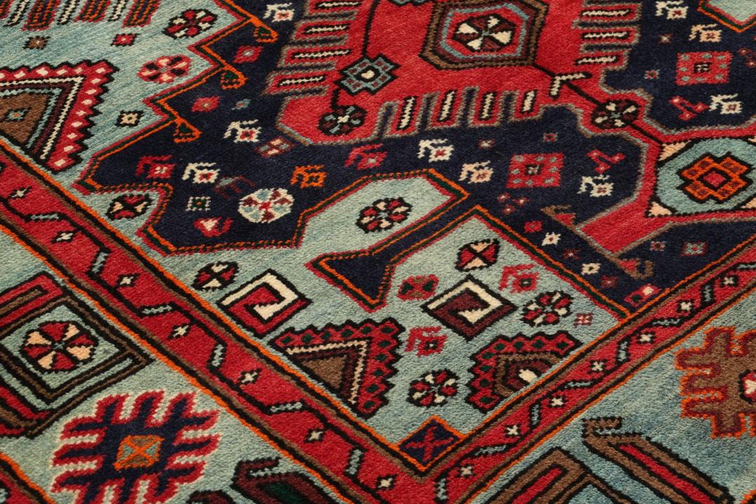 Hand-knotted Hamadan rug with traditional geometric patterns in red and blue tones from the Middle East