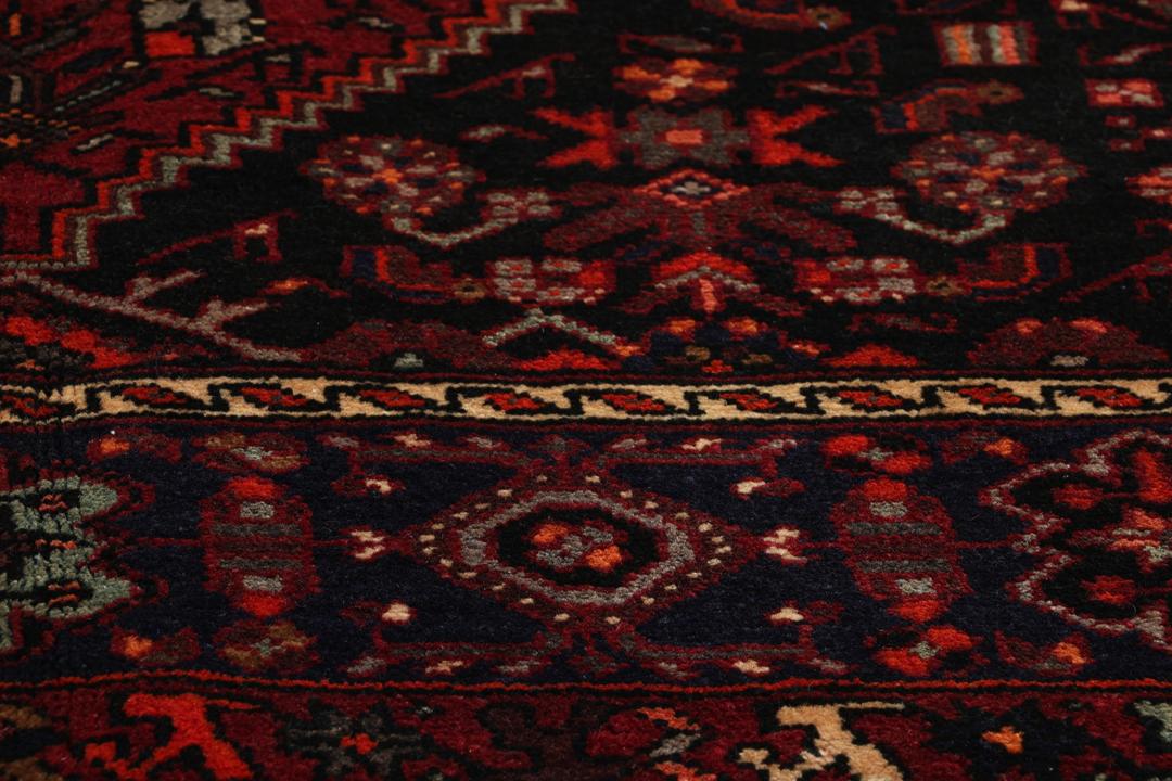 Hand-knotted Hamadan rug from the Middle East in dark red and black tones