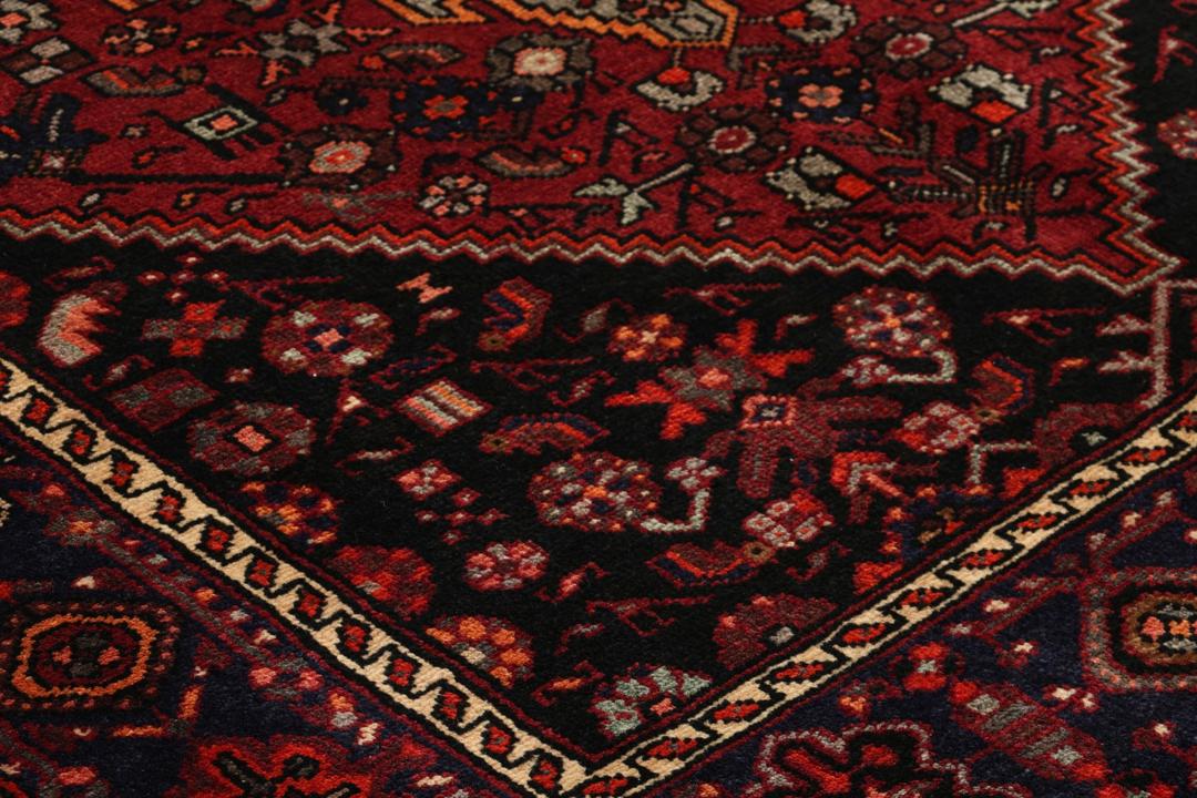 Hand-knotted Hamadan rug from the Middle East in dark red and black tones