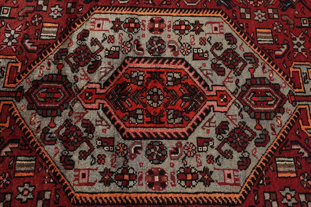 Hand-knotted Hamadan rug from the Middle East in dark red and black tones