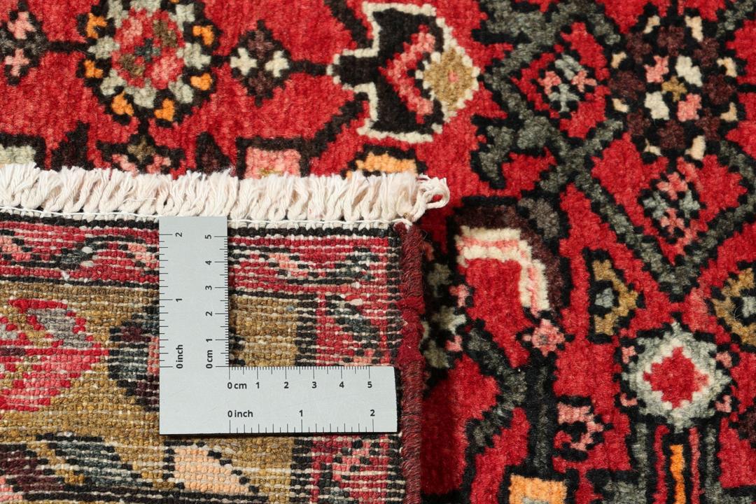 Hand-knotted Middle Eastern runner rug in vibrant red with intricate geometric patterns