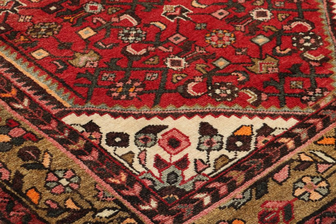 Hand-knotted Middle Eastern runner rug in vibrant red with intricate geometric patterns