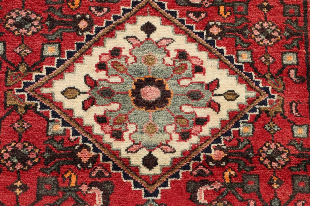 Hand-knotted Middle Eastern runner rug in vibrant red with intricate geometric patterns