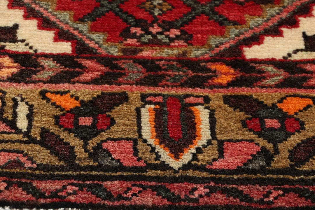 Hand-knotted Middle Eastern runner rug in vibrant red with intricate geometric patterns