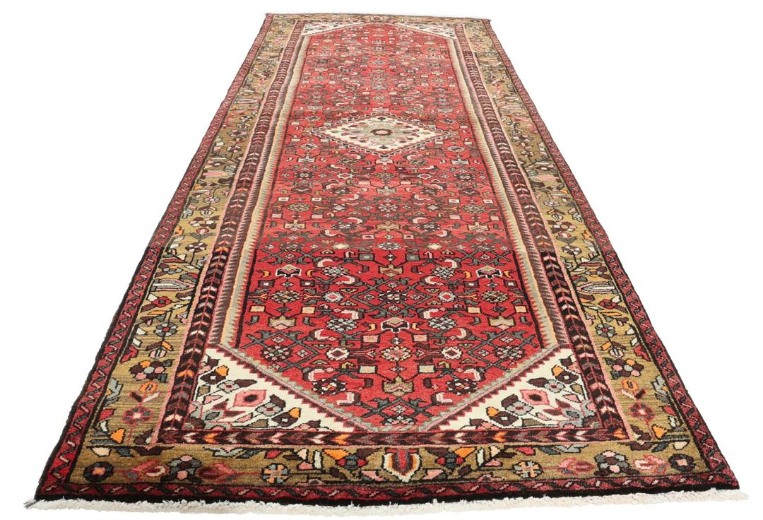 Hand-knotted Middle Eastern runner rug in vibrant red with intricate geometric patterns
