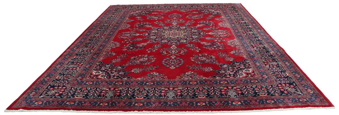 Un tapis Mashad noué à la main avec un médaillon central sur fond rouge provenant du Moyen-Orient