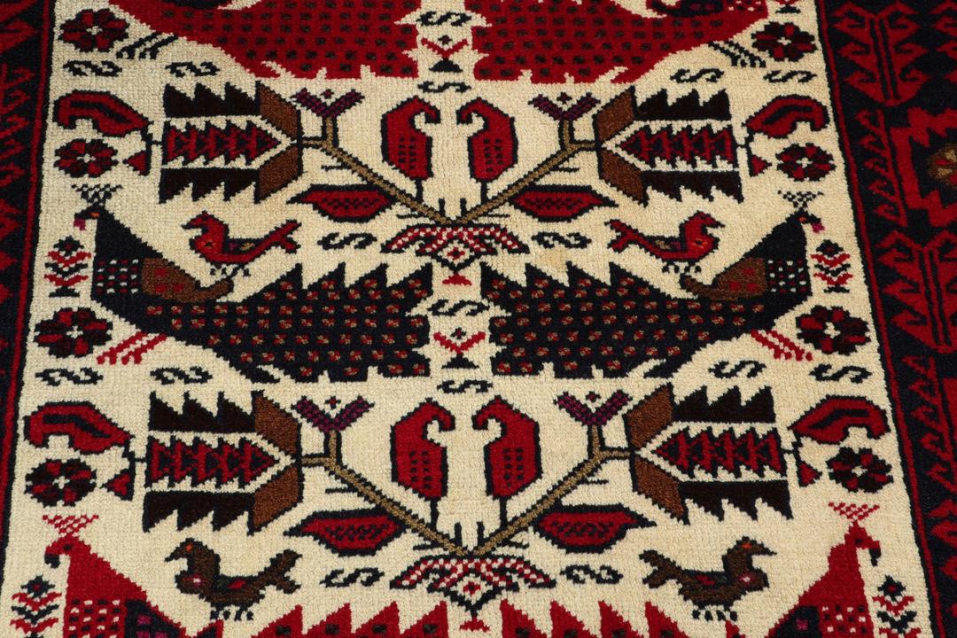 Hand-knotted Middle Eastern Baluch rug in red and cream tones