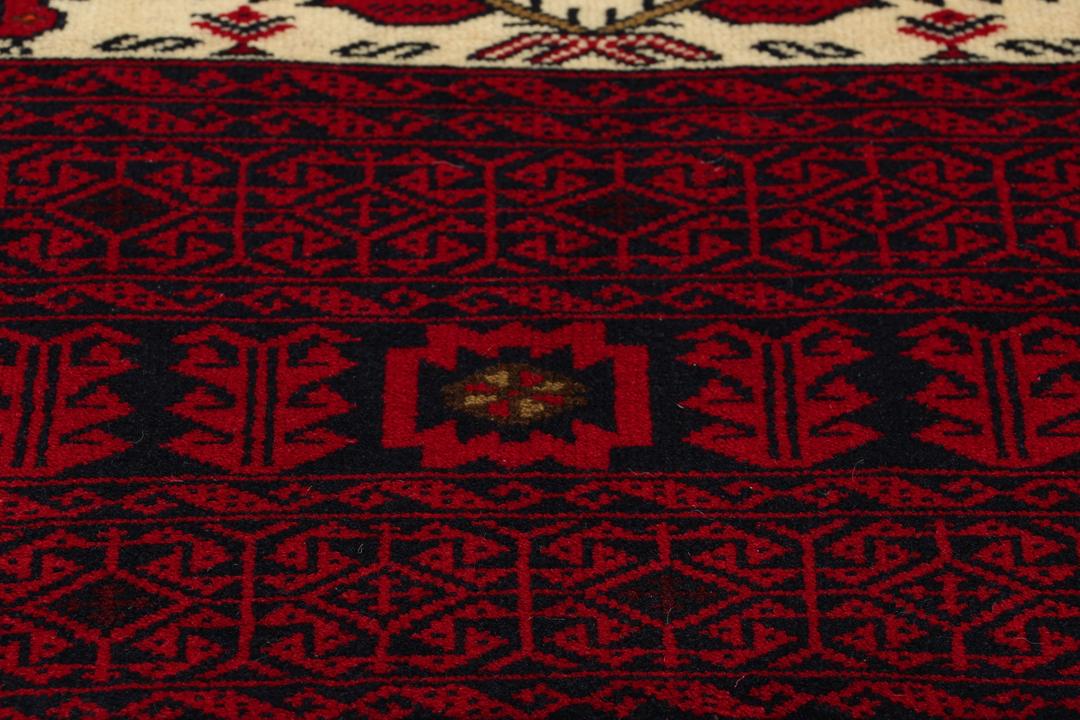 Hand-knotted Middle Eastern Baluch rug in red and cream tones