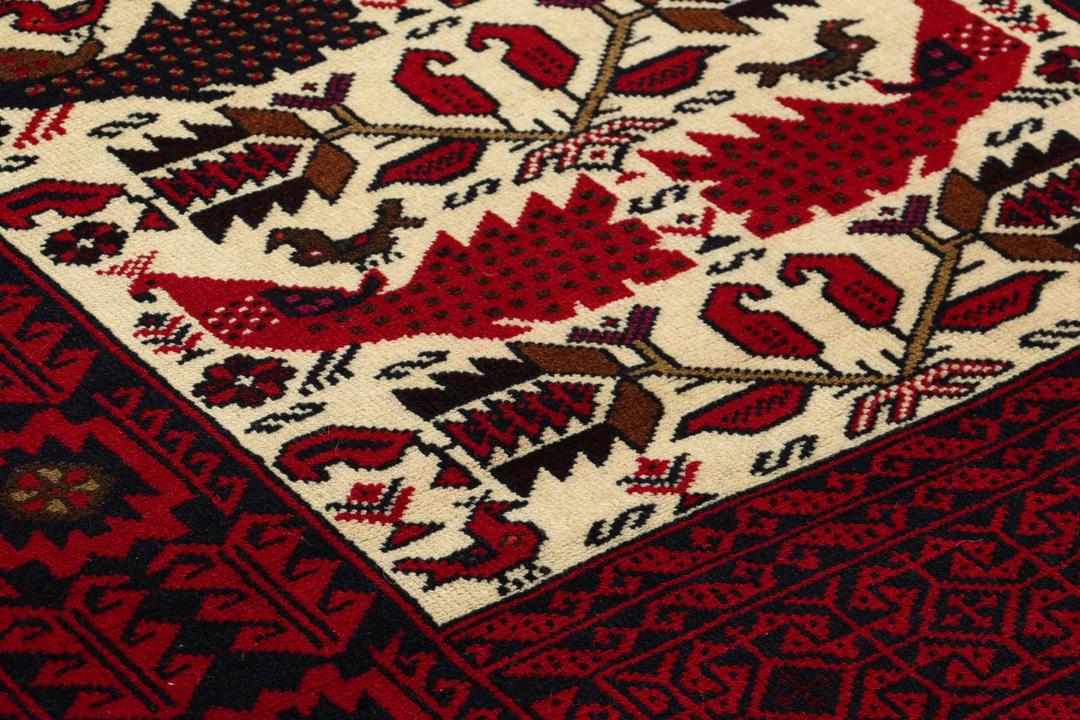 Hand-knotted Middle Eastern Baluch rug in red and cream tones
