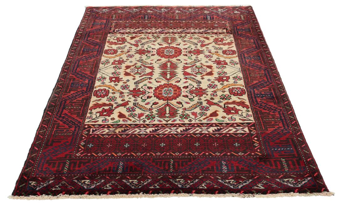 A hand-knotted Baluch rug from the Middle East featuring red and beige floral patterns.