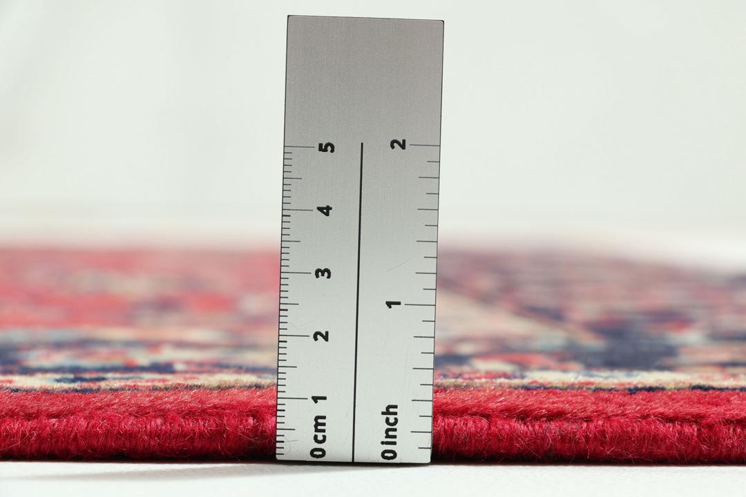 Hand-knotted Keshan rug from the Middle East featuring a vibrant red field with intricate floral patterns.