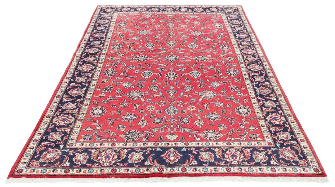 Hand-knotted Keshan rug from the Middle East featuring a vibrant red field with intricate floral patterns.
