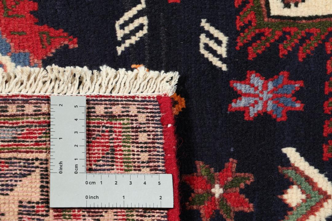 Hand-knotted Sirdjan rug from the Middle East with a dark-blue field and floral medallion pattern.