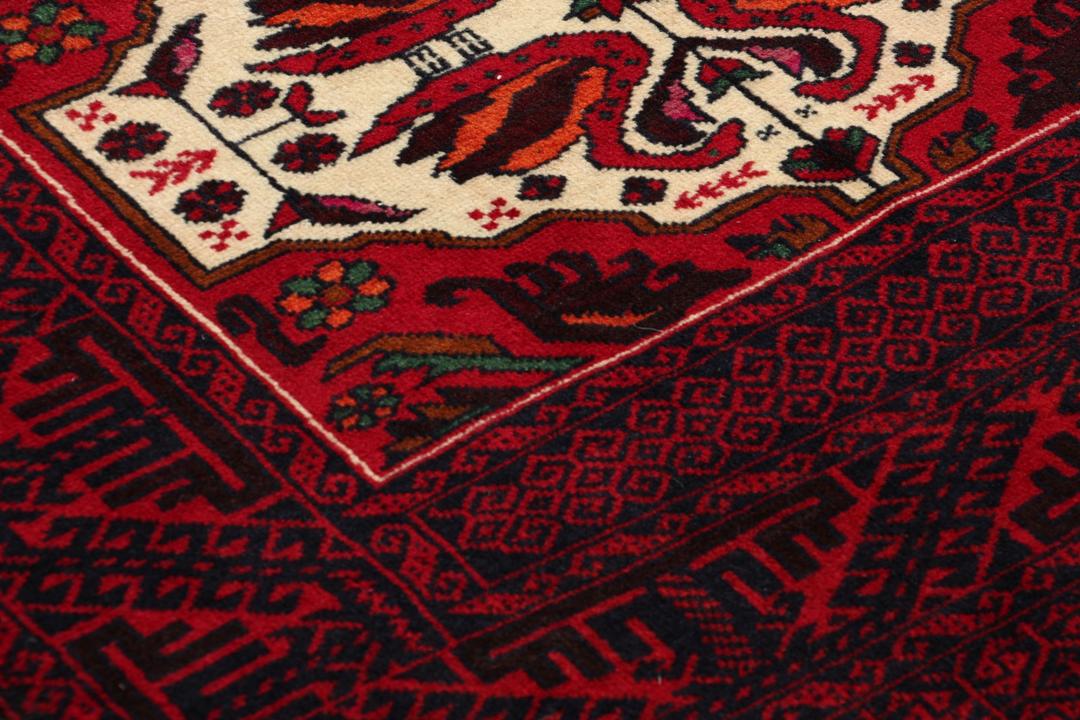 Handgeknoopt Baluch-tapijt in donkerrood met tribale medaillonmotieven uit het Midden-Oosten.