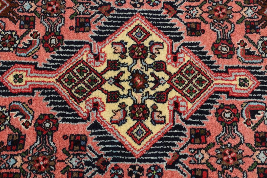 Hand knotted Asadabad rug from the Middle East in shades of red