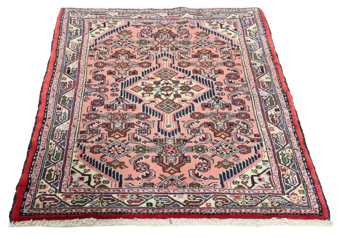 Hand knotted Asadabad rug from the Middle East in shades of red