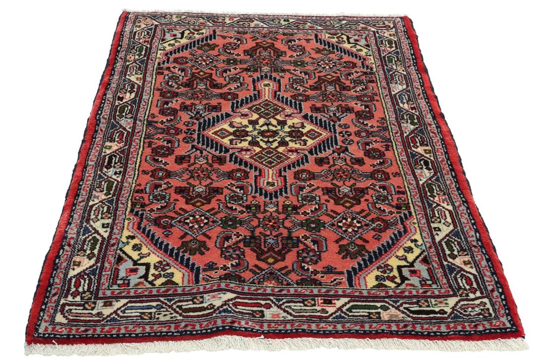 Hand knotted Asadabad rug from the Middle East in shades of red