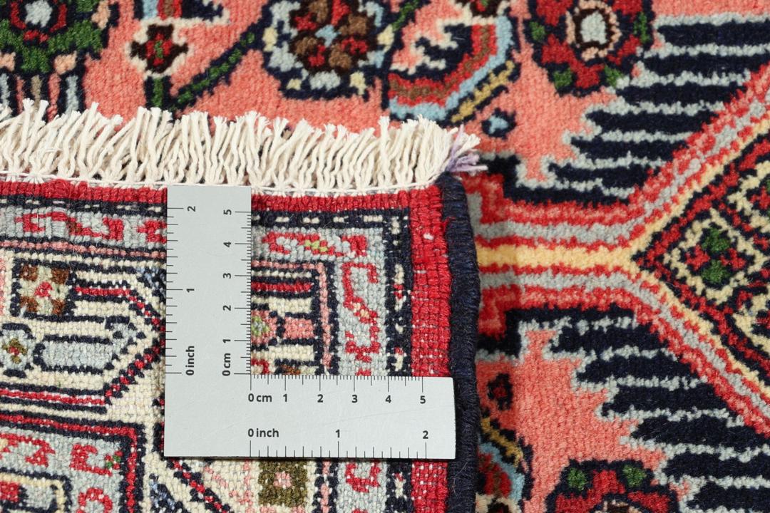 Hand knotted Asadabad rug from the Middle East in shades of red