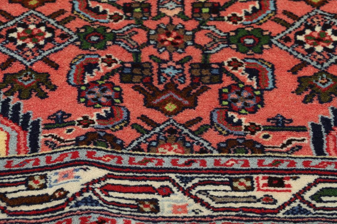 Hand knotted Asadabad rug from the Middle East in shades of red