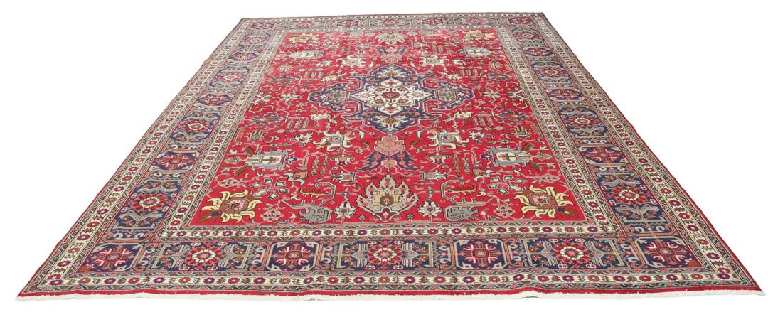 Hand-knotted Tabriz rug from the Middle East in a vibrant red colour