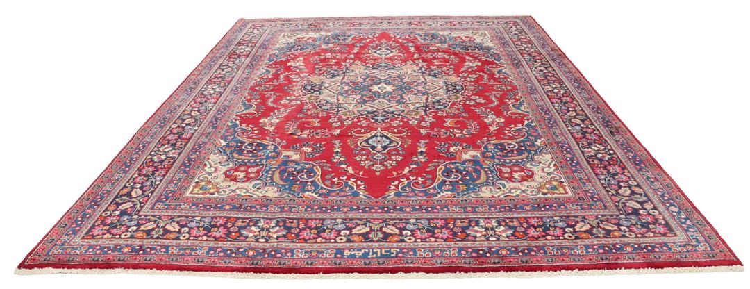 Hand-knotted Mashad rug from the Middle East with a red and blue floral pattern.