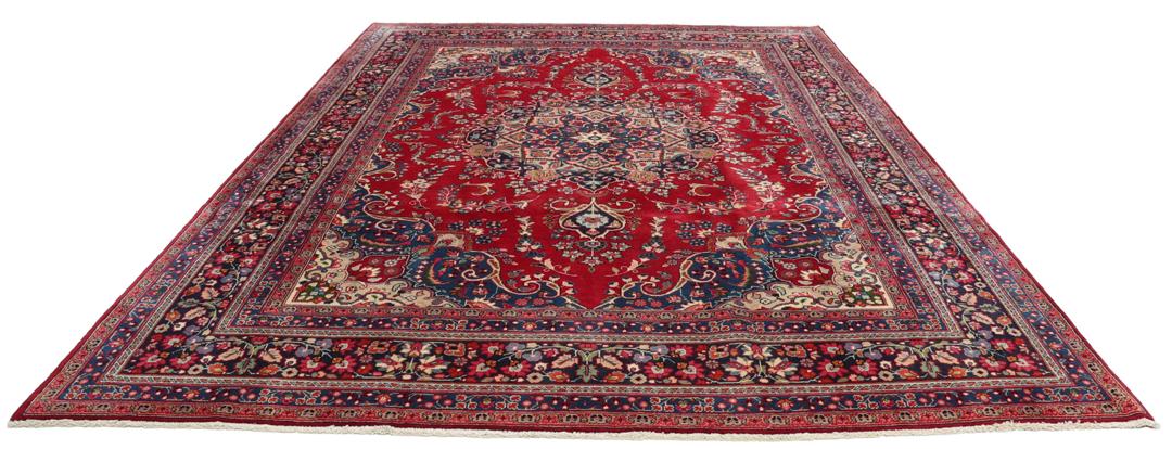Hand-knotted Mashad rug from the Middle East with a red and blue floral pattern.