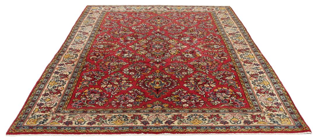A hand-knotted Sarough rug from the Middle East featuring a vibrant red field and intricate floral patterns.